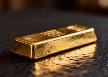Lingot d'or brillant sur fond sombre.
