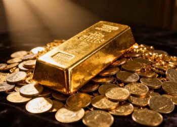 Barre d'or sur des pièces d'or.