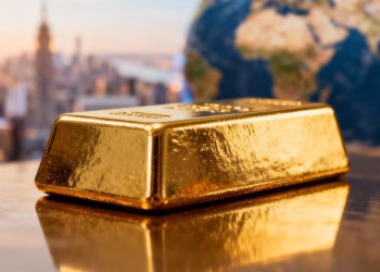 Lingot d'or brillant avec ville floue en arrière-plan.