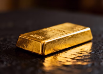 Lingot d'or brillant sur fond sombre.