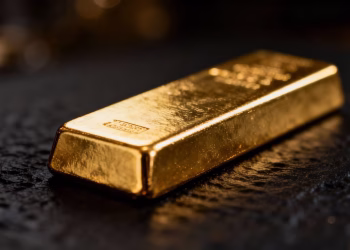 Lingot d'or brillant sur fond sombre.
