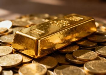 Barre d'or sur des pièces d'or.