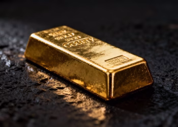 Lingot d'or brillant sur fond sombre.