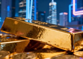 Lingot d'or brillant avec une ville floue en arrière-plan.