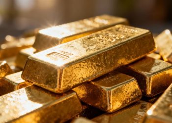 Lingots d'or brillants sur un fond sombre.
