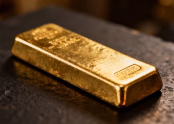 Lingot d'or brillant sur fond sombre, symbole de sécurité.