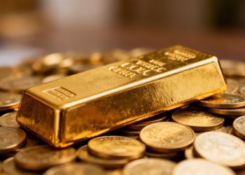 Barre d'or sur des pièces d'or, symbole d'investissement.