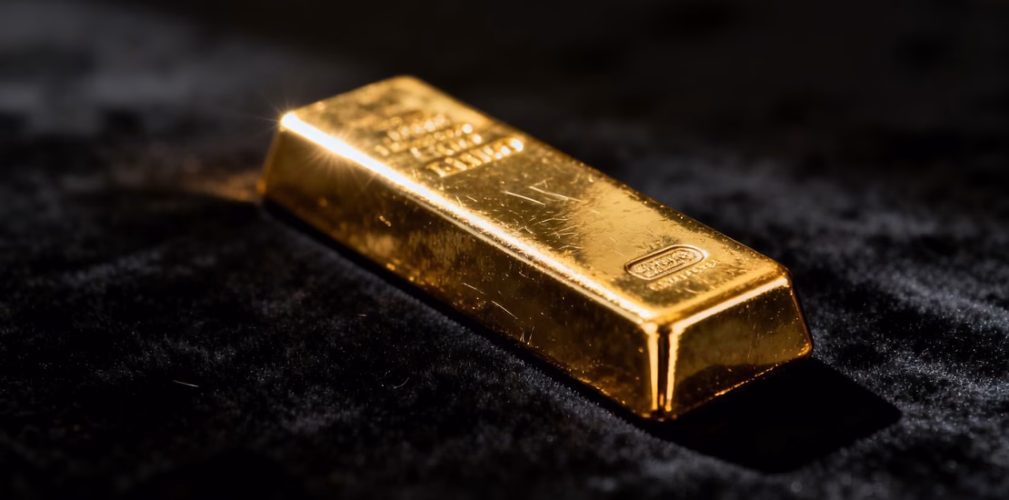 Lingot d'or brillant sur fond sombre.