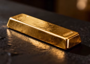 Lingot d'or sur fond sombre, symbole de richesse.