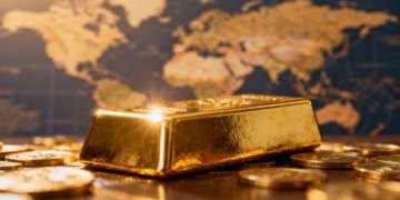 Lingot d'or sur fond de carte du monde floue.