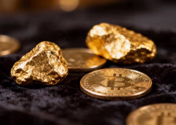 Shiny gold bars and coins, close-up.