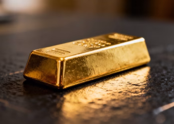 Lingot d'or brillant sur fond sombre.