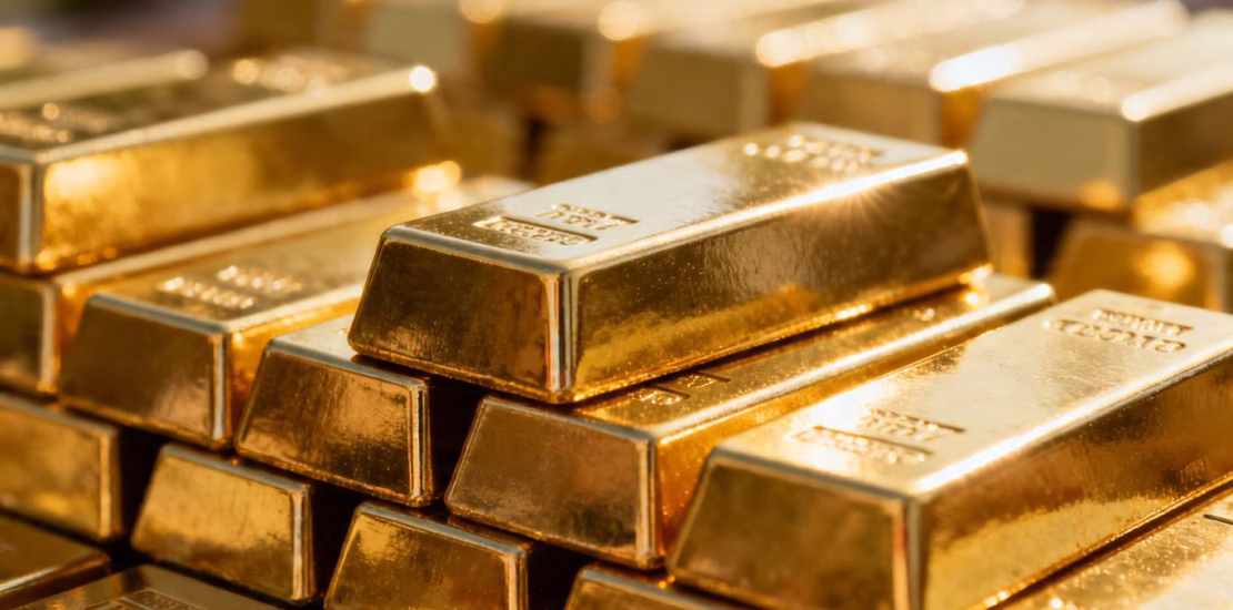 Shiny gold bars stacked, close-up.