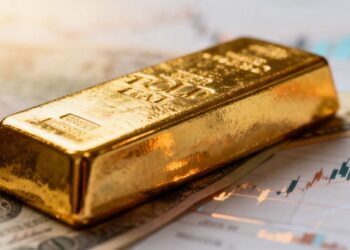 Lingot d'or brillant avec fond flou économique.