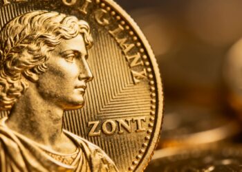 أونصة ذهبية لامعة على خلفية محايدة.