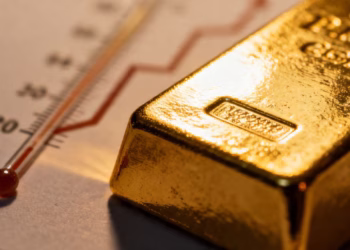 Gold ingot and thermometer symbolizing inflation.