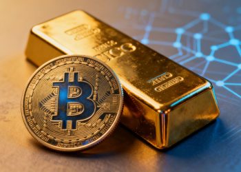 Barre d'or et pièce de cryptomonnaie numérique.